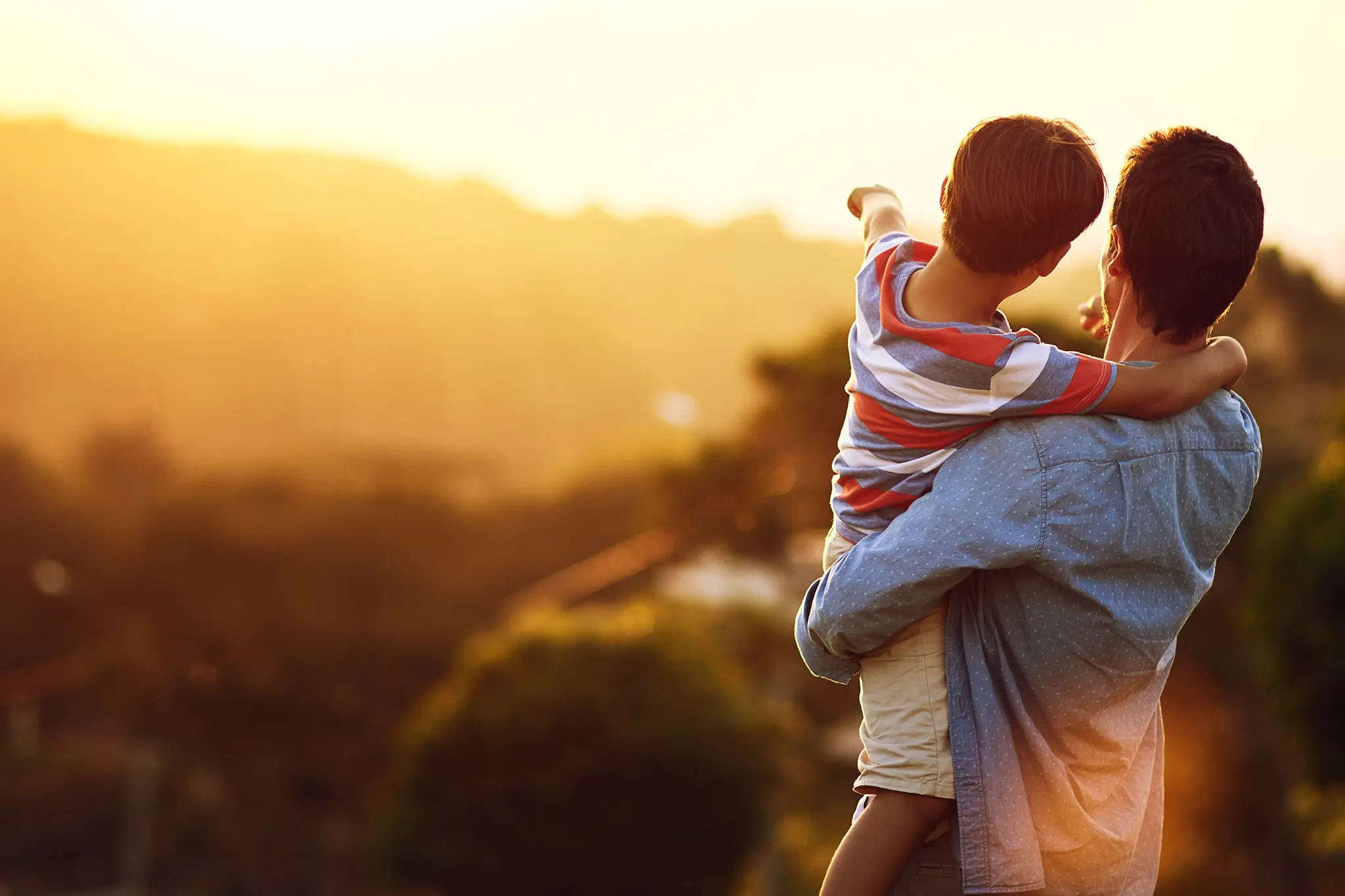 A father and son enjoying a sunset.