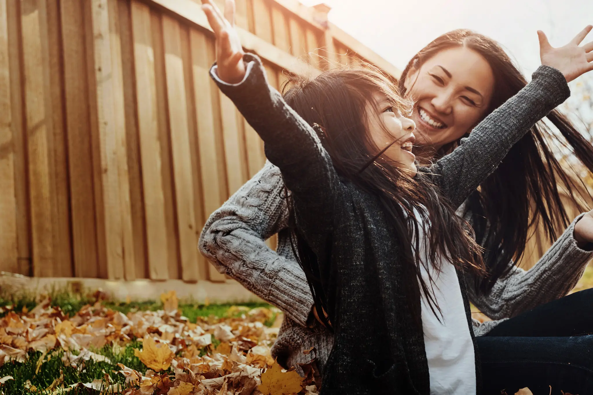 A child expressing joy with her mother.