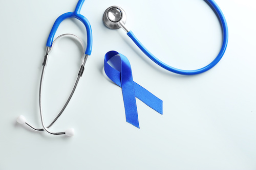 blue stethoscope and ribbon on white background