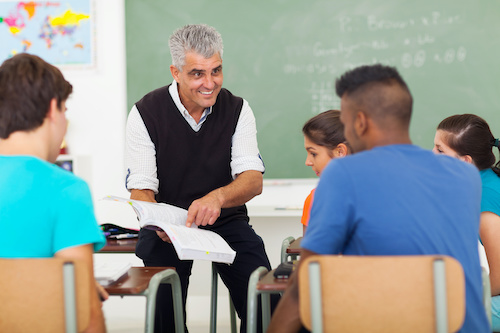 older man teaching high school students