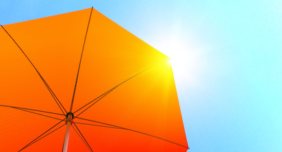 orange sun umbrella against blue sky
