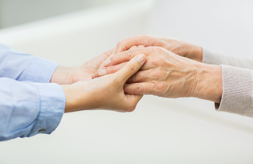 closeup of two people holding hands