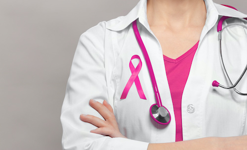 pink ribbon and pink stethoscope on light grey background