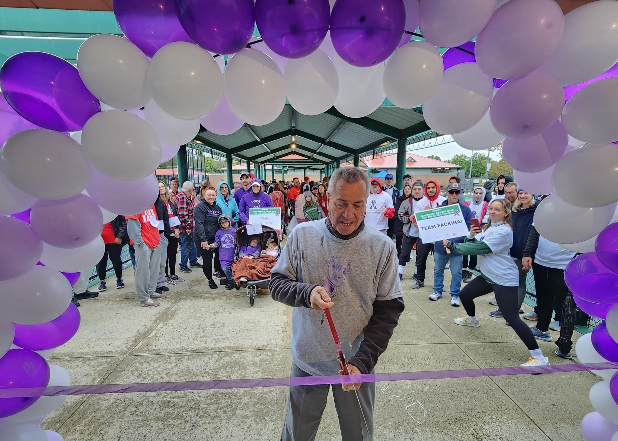 Ron rios cutting ribbon at walk for a cure event