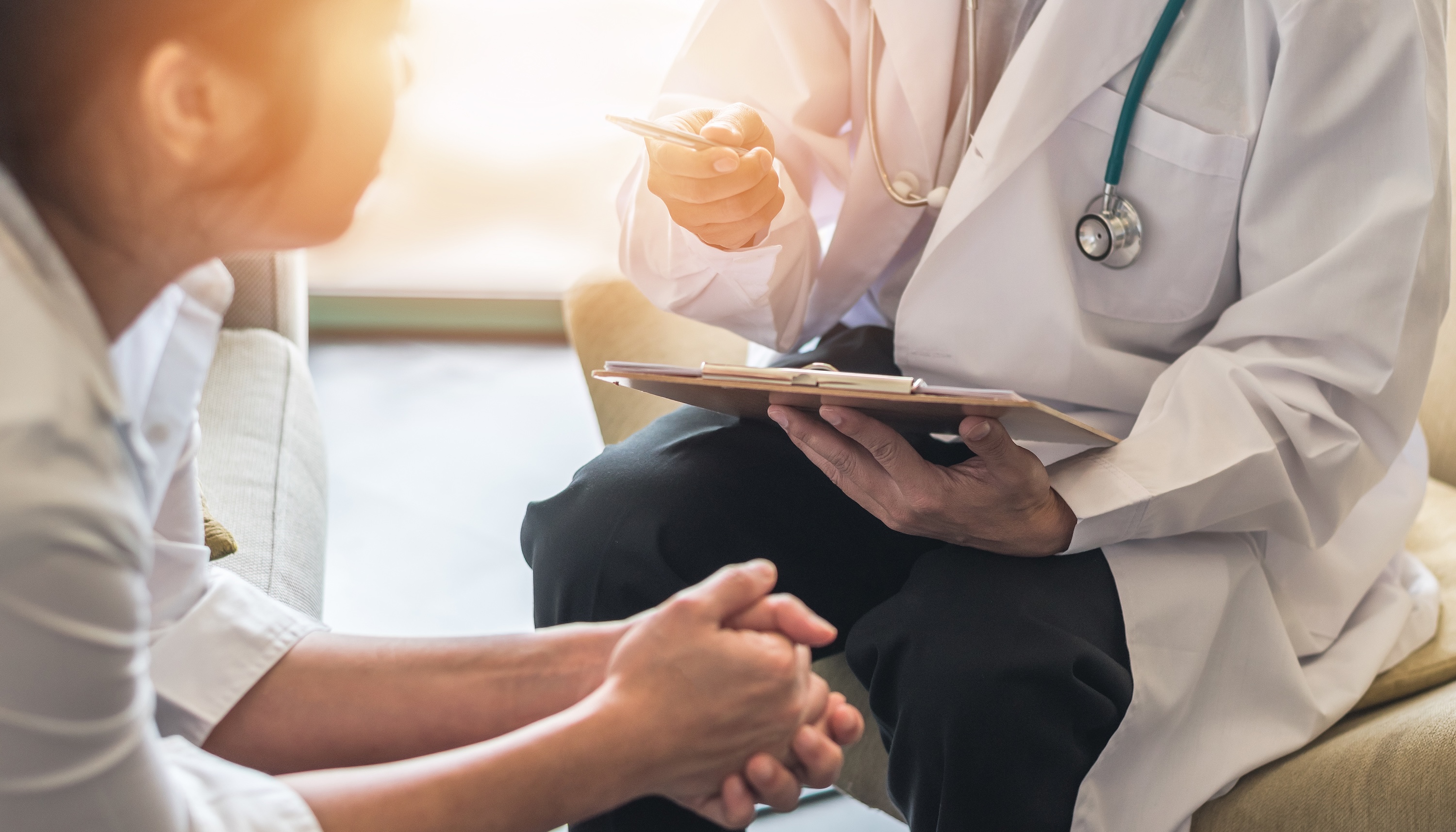 Doctor reviewing health chart with patient