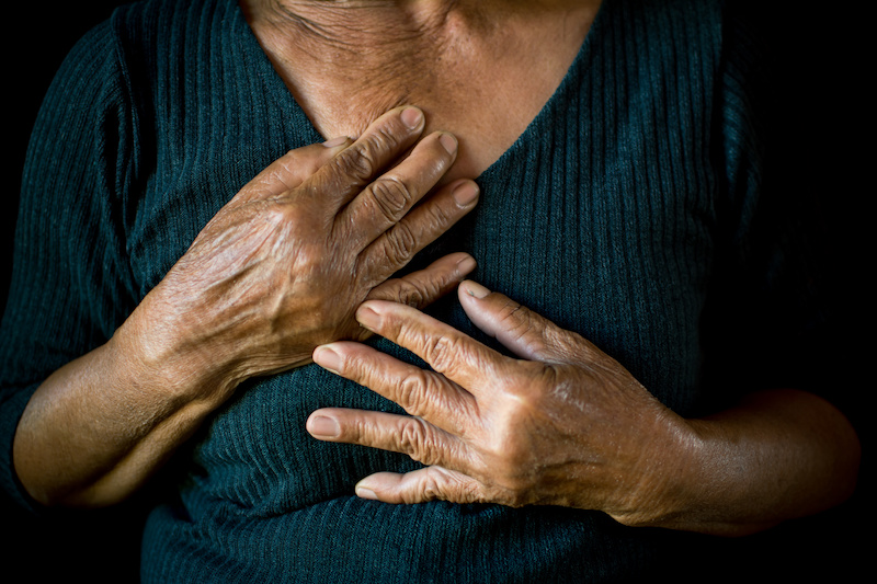 Close up of woman of color grabbing her chest