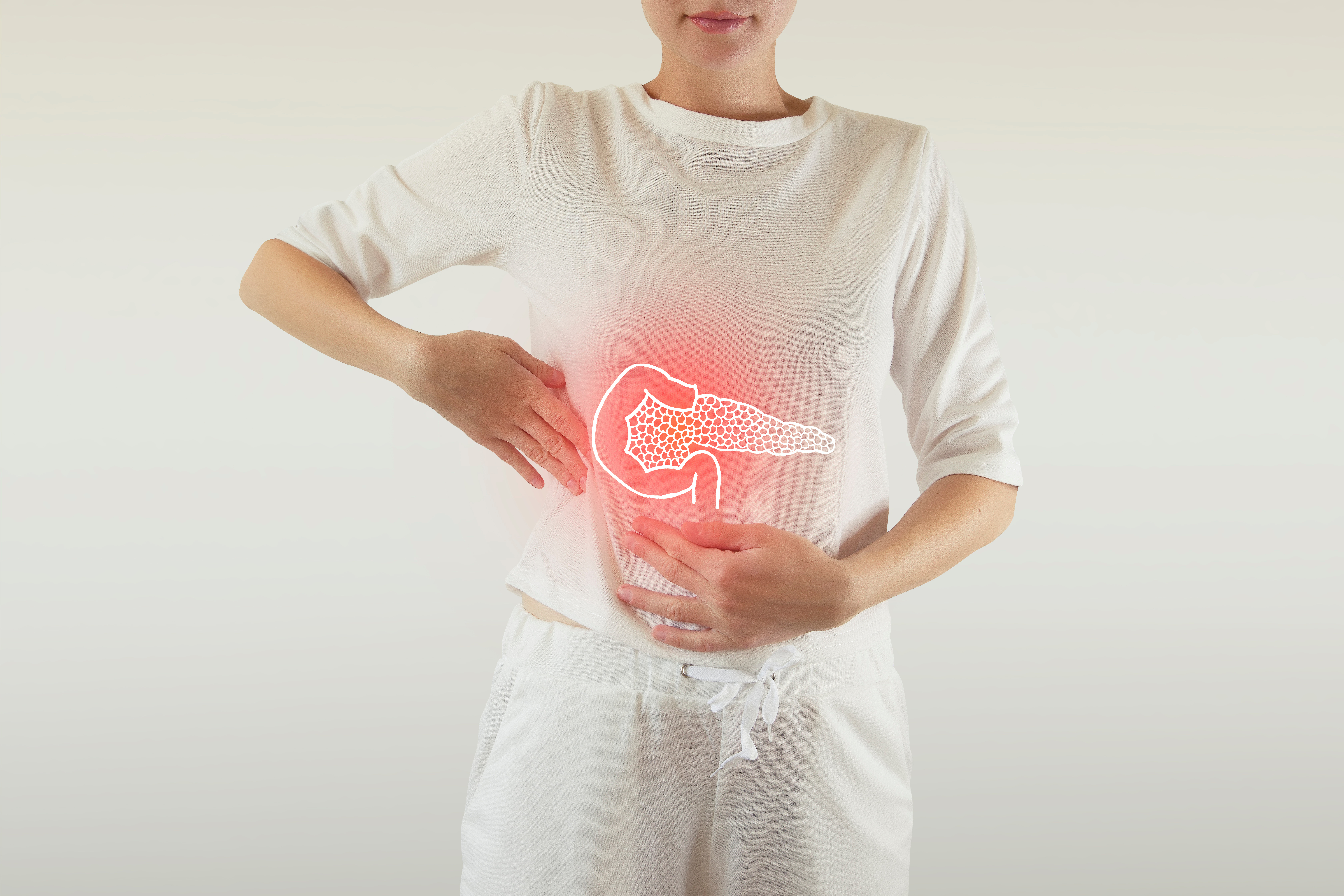 Woman in white tshirt holding stomach area with glowing model of pancreas