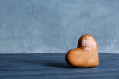 Wooden heart with bandaid