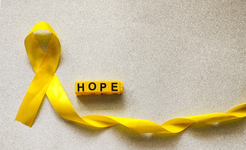 yellow ribbon and yellow connecting blocks spelling out HOPE