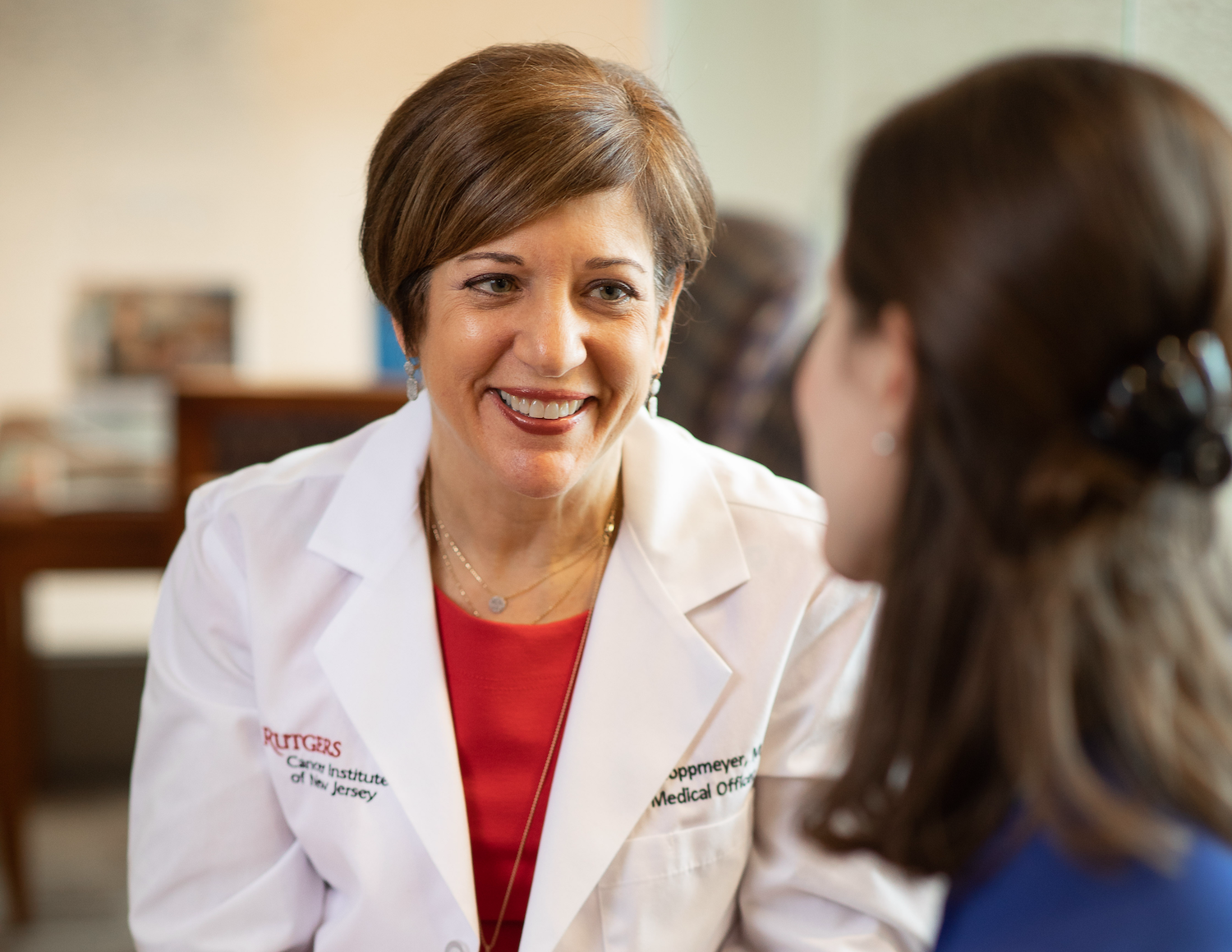 Dr. Toppmeyer smiling at patient during conversation