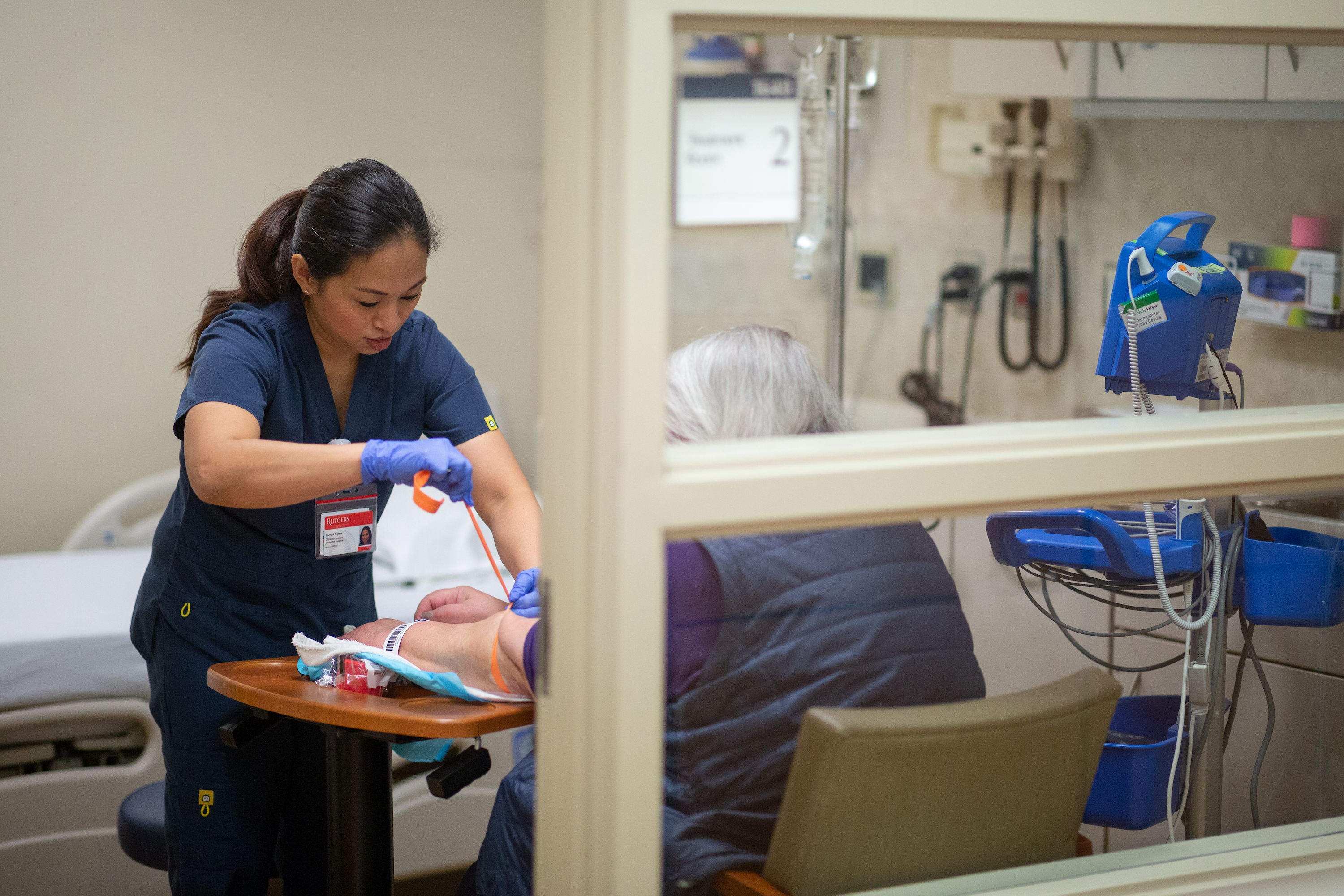 Nurse taking blood from adult patient