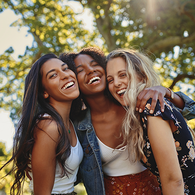 three young adult women of diverse backgrounds