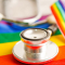 stethoscope sitting on top of a pride flag