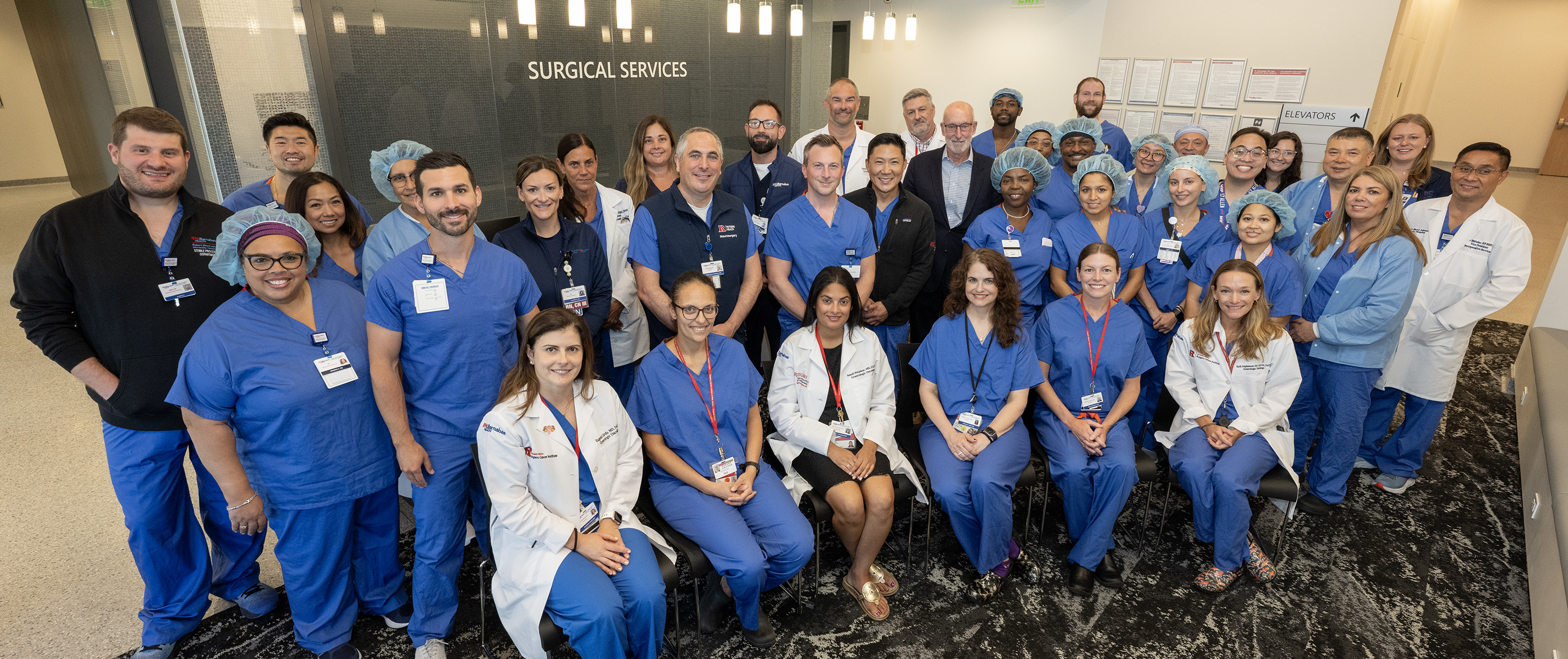 Surgical team standing over patient in Operating Room
